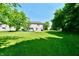 Spacious backyard featuring a lush green lawn and mature trees, perfect for outdoor activities at 10519 Hyacinth Ct, Noblesville, IN 46060