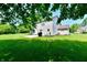 Grassy backyard with a small patio and access to the home's exterior and back door at 10519 Hyacinth Ct, Noblesville, IN 46060