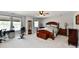 Spacious bedroom with ample natural light, wood furniture, and ceiling fan for a comfortable retreat at 10519 Hyacinth Ct, Noblesville, IN 46060