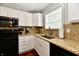 Kitchen featuring granite counters, black appliances, and a stainless steel sink and fixtures at 10519 Hyacinth Ct, Noblesville, IN 46060