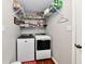 Functional laundry room with washer, dryer, and storage shelving, ideal for efficient home maintenance at 10519 Hyacinth Ct, Noblesville, IN 46060