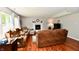 Cozy living room with hardwood floors, a fireplace, and comfortable seating at 10519 Hyacinth Ct, Noblesville, IN 46060