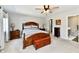 An expansive main bedroom featuring a ceiling fan, wooden furniture, and carpeted floors at 10519 Hyacinth Ct, Noblesville, IN 46060