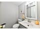 A half bathroom offers a modern vanity, toilet, and stylish mirror, providing a convenient space at 10519 Hyacinth Ct, Noblesville, IN 46060