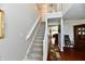 Carpeted staircase with white railings leading to the upper level of the home, creating an inviting entry at 10519 Hyacinth Ct, Noblesville, IN 46060