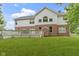 Spacious backyard featuring a large deck, lush lawn, and a charming two-story home with a brick and siding exterior at 11036 Ravenna Way, Indianapolis, IN 46236