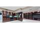 Basement kitchenette with stainless steel appliances, granite countertop, and custom cabinetry at 11036 Ravenna Way, Indianapolis, IN 46236