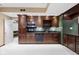 Basement kitchenette features stainless steel appliances, custom cabinets, and granite counters at 11036 Ravenna Way, Indianapolis, IN 46236