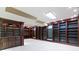 Finished basement with extensive dark wood shelving, neutral carpet, and recessed lights at 11036 Ravenna Way, Indianapolis, IN 46236