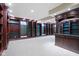 Finished basement with custom dark wood bookcases, neutral carpet, and recessed lighting at 11036 Ravenna Way, Indianapolis, IN 46236