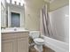 Bathroom with a toilet, vanity and a shower/tub with neutral colored curtain at 11036 Ravenna Way, Indianapolis, IN 46236