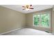 Bedroom with carpeted floor, neutral paint and large window with a treed view at 11036 Ravenna Way, Indianapolis, IN 46236