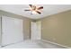 Bright bedroom featuring a ceiling fan, neutral walls, and a spacious closet for storage at 11036 Ravenna Way, Indianapolis, IN 46236