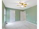 Well-lit bedroom with ceiling fan, two doors, and neutral carpet at 11036 Ravenna Way, Indianapolis, IN 46236