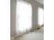 Bright room with sheer curtains covering large windows and neutral carpeting at 11036 Ravenna Way, Indianapolis, IN 46236