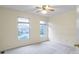 Bedroom with neutral walls, ceiling fan, and natural light from two windows at 11036 Ravenna Way, Indianapolis, IN 46236