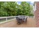 Deck with outdoor metal furniture, seating and natural backdrop with lush green trees at 11036 Ravenna Way, Indianapolis, IN 46236