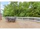 Deck with outdoor metal furniture, seating and natural backdrop with lush green trees at 11036 Ravenna Way, Indianapolis, IN 46236