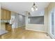 A dining area has hardwood floors and is adjacent to other living spaces in the home at 11036 Ravenna Way, Indianapolis, IN 46236