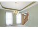 This dining room includes natural light, views, and a wooden staircase visible just off the dining area at 11036 Ravenna Way, Indianapolis, IN 46236