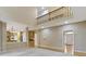 Open-concept foyer showcases an open staircase and view to kitchen at 11036 Ravenna Way, Indianapolis, IN 46236