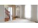 Bright, airy foyer with hardwood floors, a staircase, and large windows bringing in natural light at 11036 Ravenna Way, Indianapolis, IN 46236