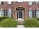 Charming front entrance framed by manicured shrubs, brick archway, and classic black shutters at 11036 Ravenna Way, Indianapolis, IN 46236