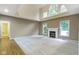 Bright living room featuring a fireplace, high ceilings, and large windows offering ample natural light at 11036 Ravenna Way, Indianapolis, IN 46236