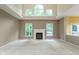 Bright living room featuring a fireplace, high ceilings, and large windows offering ample natural light at 11036 Ravenna Way, Indianapolis, IN 46236