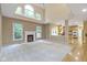 Bright living room featuring a fireplace, high ceilings, and open view to the kitchen at 11036 Ravenna Way, Indianapolis, IN 46236