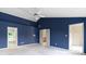 Main bedroom with plush carpet, blue accent wall, ceiling fan and ensuite bathroom and walk-in closet at 11036 Ravenna Way, Indianapolis, IN 46236
