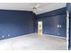 Spacious main bedroom featuring a vaulted ceiling, blue accent wall, and plush carpet at 11036 Ravenna Way, Indianapolis, IN 46236