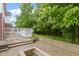 Concrete patio is surrounded by lush green trees and a white fenced in deck area at 11036 Ravenna Way, Indianapolis, IN 46236