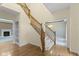 Elegant staircase with carpeted steps, hardwood floors, and views into adjacent living spaces at 11036 Ravenna Way, Indianapolis, IN 46236