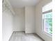 Carpeted walk-in closet with window and wall-mounted shelving at 11036 Ravenna Way, Indianapolis, IN 46236