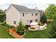 Expansive backyard with a patio, seating, lush greenery, and outdoor dining at 1237 Wolcott Ct, Westfield, IN 46074