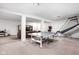This finished basement has carpet and offers a ping pong table, a leather sofa and more at 1237 Wolcott Ct, Westfield, IN 46074