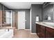 This bathroom offers a shower and tub, double sink vanity, and neutral tile at 1237 Wolcott Ct, Westfield, IN 46074