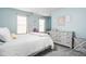 This bedroom is decorated with soft colors, two windows, and a chandelier at 1237 Wolcott Ct, Westfield, IN 46074