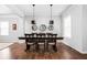 Cozy dining room with hardwood flooring, stylish lighting, and a view into adjacent living space at 1237 Wolcott Ct, Westfield, IN 46074