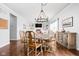 Dining area featuring hardwood flooring, a modern chandelier, and access to the living room at 1237 Wolcott Ct, Westfield, IN 46074