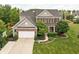 Charming home featuring a brick facade, well-kept lawn, and an attached two-car garage at 1237 Wolcott Ct, Westfield, IN 46074