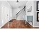 Elegant foyer with hardwood floors, a staircase with a wrought iron railing, and stylish decor at 1237 Wolcott Ct, Westfield, IN 46074
