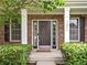 Welcoming front porch showcasing a decorative front door, sidelights, and manicured shrubs at 1237 Wolcott Ct, Westfield, IN 46074
