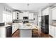 Modern kitchen featuring white cabinets, granite countertops, a center island, and stainless steel appliances at 1237 Wolcott Ct, Westfield, IN 46074