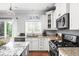Well-appointed kitchen boasting granite counters, a gas range, and modern white cabinetry at 1237 Wolcott Ct, Westfield, IN 46074