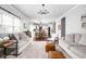 Open-concept living room featuring hardwood flooring, a dining table and kitchen with a center island at 1237 Wolcott Ct, Westfield, IN 46074