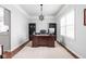 Bright home office featuring a large desk, custom shelves, and ample natural light through windows at 1237 Wolcott Ct, Westfield, IN 46074