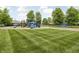 A colorful playground area with slides and climbing equipment, set against a green lawn at 1237 Wolcott Ct, Westfield, IN 46074