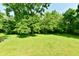 Expansive backyard with lush greenery and mature trees providing a serene setting at 12380 Creekwood Ln, Carmel, IN 46032
